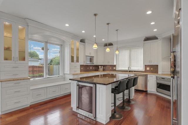 8453 W Bruce Dr, Niles, IL 60714 - kitchen featuring stainless steel appliances, beverage cooler, white cabinets, a kitchen bar, and dark wood-style floors