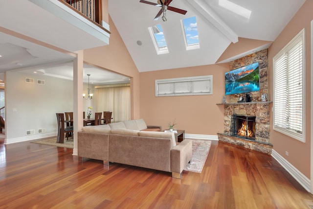8453 W Bruce Dr, Niles, IL 60714 - living room featuring a stone fireplace, wood finished floors, a ceiling fan, healthy amount of natural light, and beam ceiling
