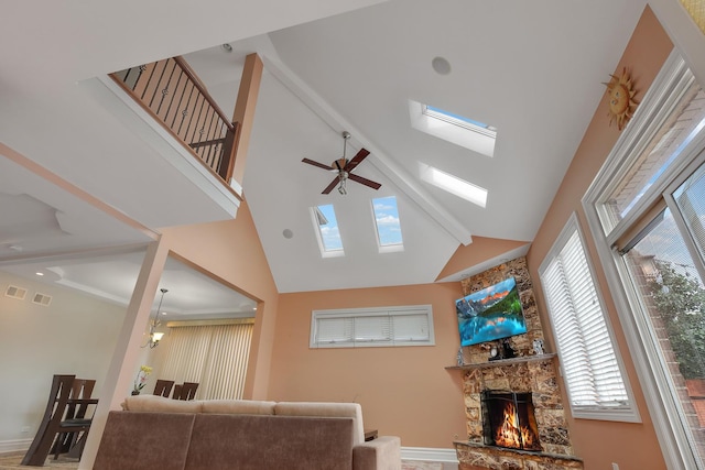 8453 W Bruce Dr, Niles, IL 60714 - living area featuring high vaulted ceiling, a ceiling fan, a stone fireplace, and a skylight