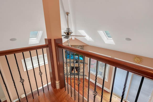 8453 W Bruce Dr, Niles, IL 60714 - staircase featuring a skylight, wood finished floors, lofted ceiling, and a stone fireplace