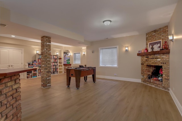 8453 W Bruce Dr, Niles, IL 60714 - recreation room featuring ornate columns, a fireplace, and wood finished floors