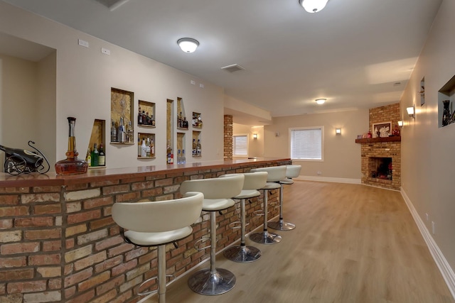 8453 W Bruce Dr, Niles, IL 60714 - indoor dry bar with wood finished floors and a brick fireplace