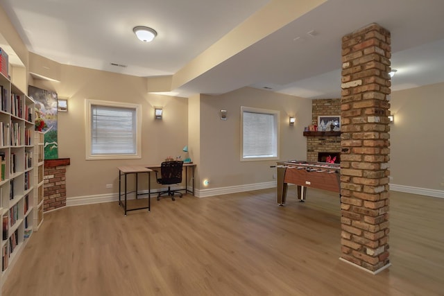 8453 W Bruce Dr, Niles, IL 60714 - office with wood finished floors, ornate columns, a fireplace, and plenty of natural light