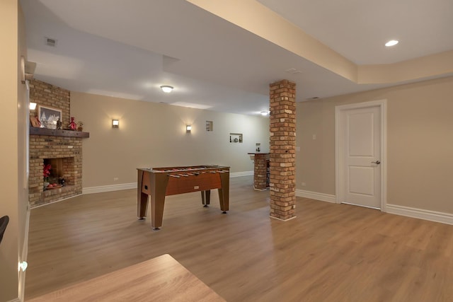 8453 W Bruce Dr, Niles, IL 60714 - rec room with ornate columns, a fireplace, light wood-type flooring, and recessed lighting
