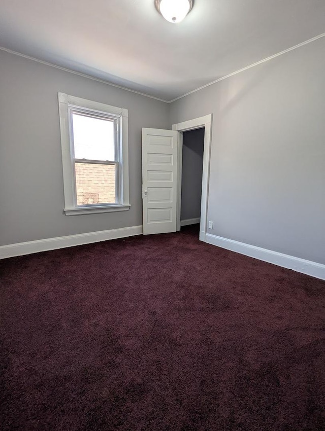 8817 S Elizabeth St, Chicago, IL 60620 - spare room featuring dark colored carpet and crown molding