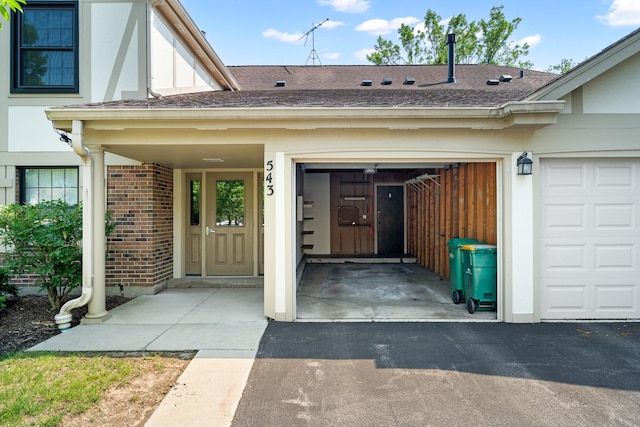 543 Williamsburg Ct Unit C2, Wheeling, IL 60090 - doorway to property with brick siding, roof with shingles, driveway, and an attached garage