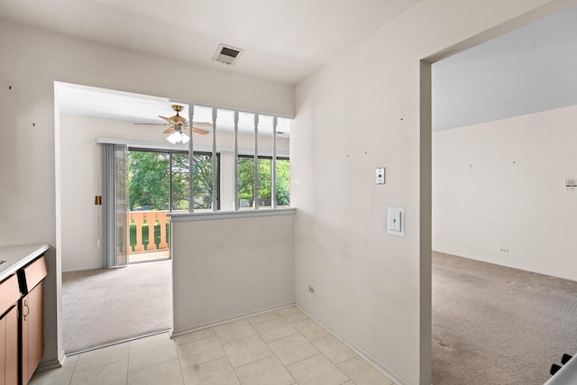543 Williamsburg Ct Unit C2, Wheeling, IL 60090 - unfurnished dining area featuring light carpet, a ceiling fan, and light tile patterned floors
