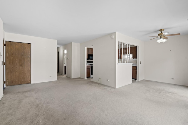 543 Williamsburg Ct Unit C2, Wheeling, IL 60090 - unfurnished living room featuring light colored carpet and a ceiling fan