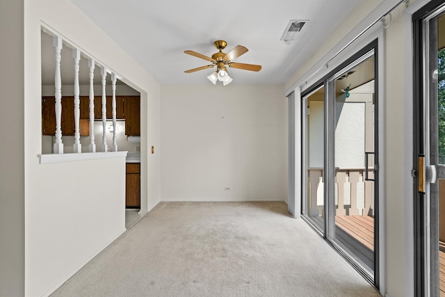 543 Williamsburg Ct Unit C2, Wheeling, IL 60090 - unfurnished room with light colored carpet, ceiling fan, and plenty of natural light