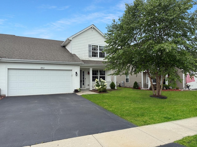 251 Maryland Ln, Pingree Grove, IL 60140 - view of front of house with driveway, a garage, a front lawn, roof with shingles, and a porch