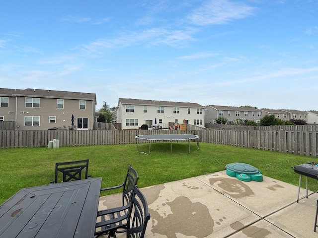 251 Maryland Ln, Pingree Grove, IL 60140 - fenced backyard with a trampoline, a residential view, a patio, and outdoor dining space