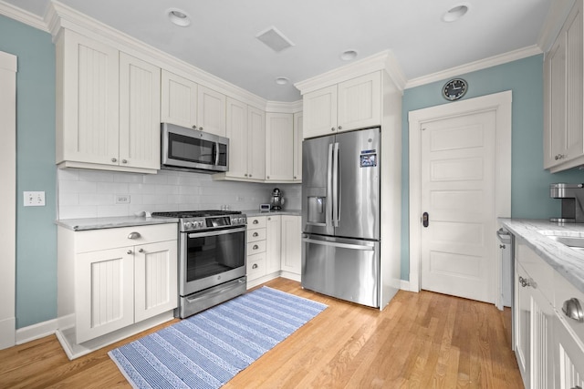 1718 Lake Ave, Wilmette, IL 60091 - kitchen with stainless steel appliances, backsplash, crown molding, light stone counters, and light wood-style flooring