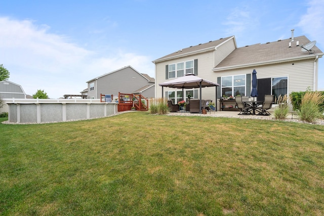 8102 Expedition St, Joliet, IL 60431 - rear view of property featuring a gazebo, an outdoor pool, a lawn, a patio, and outdoor lounge area