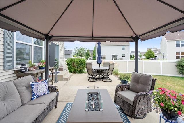 8102 Expedition St, Joliet, IL 60431 - view of patio featuring a gazebo, an outdoor living space with a fire pit, outdoor dining space, and a residential view