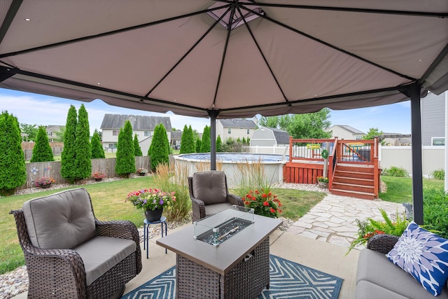 8102 Expedition St, Joliet, IL 60431 - fenced backyard featuring a deck, a patio, a gazebo, and an outdoor living space with a fire pit