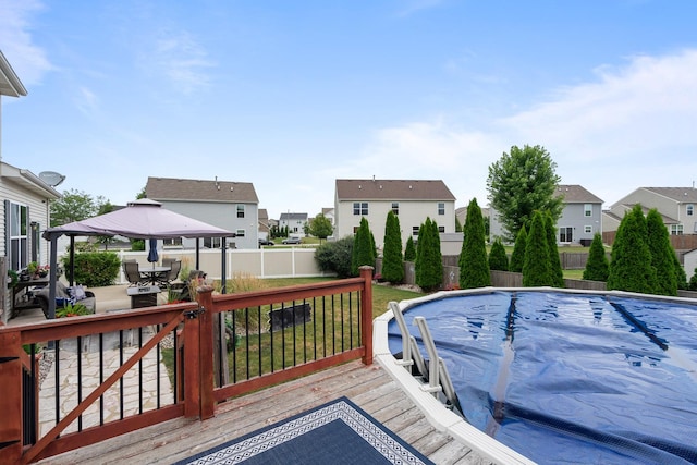 8102 Expedition St, Joliet, IL 60431 - deck featuring a residential view, a gazebo, a fenced backyard, a patio area, and outdoor dining area