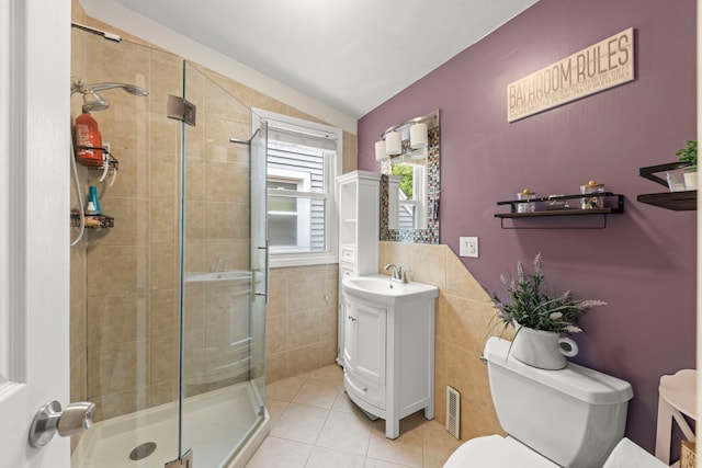 3812 N Pioneer Ave, Chicago, IL 60634 - bathroom with tile walls, vanity, a stall shower, and tile patterned floors