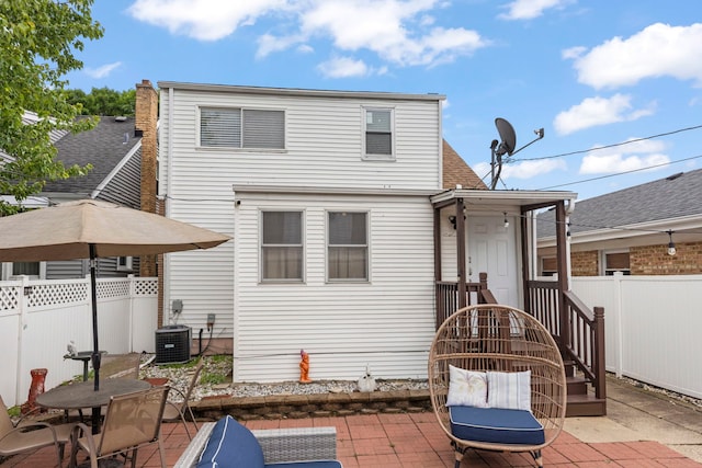 3812 N Pioneer Ave, Chicago, IL 60634 - back of property with a patio area and a shingled roof
