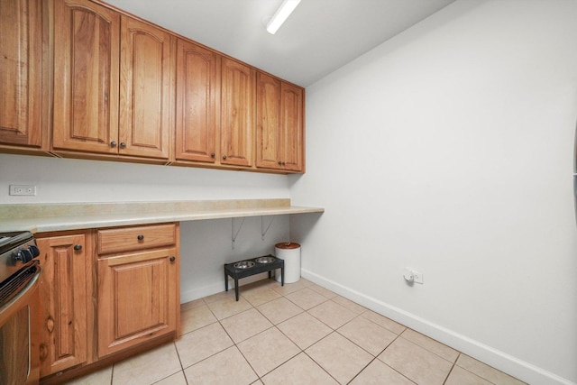 2021 S Wolf Rd Unit 2-118, Hillside, IL 60162 - laundry room with light tile patterned flooring and an office area