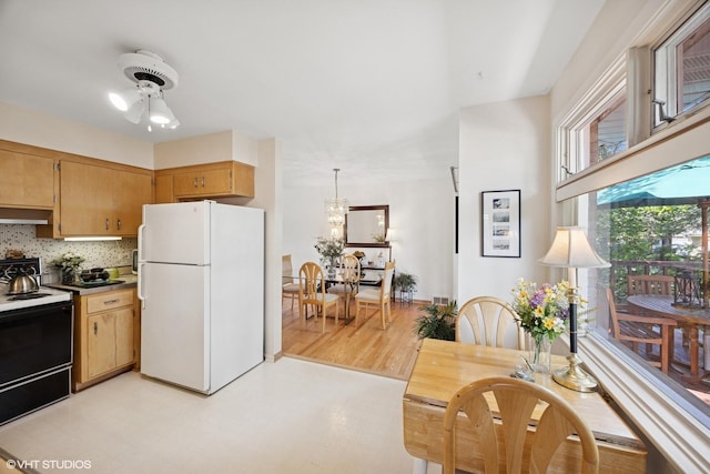 1865 Sunnyside Ave, Westchester, IL 60154 - kitchen with freestanding refrigerator, range with electric stovetop, under cabinet range hood, decorative backsplash, and light flooring