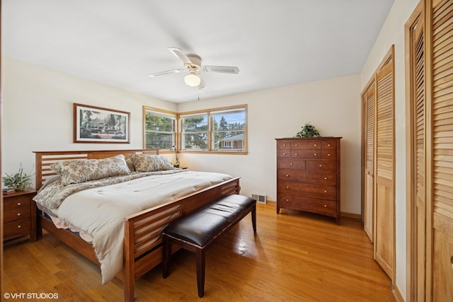 1865 Sunnyside Ave, Westchester, IL 60154 - bedroom with light wood-style flooring, two closets, and a ceiling fan