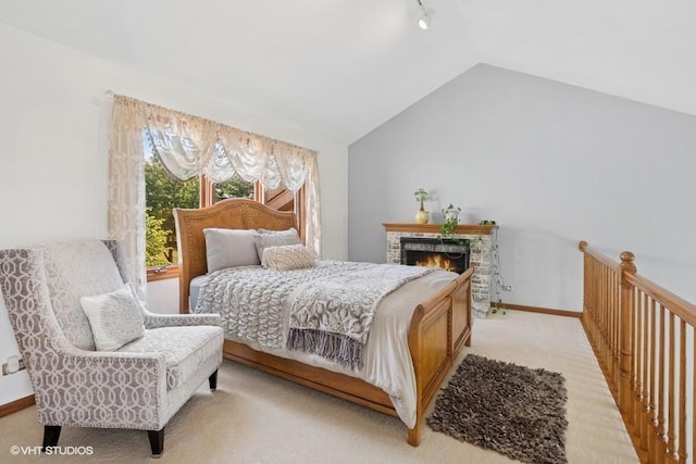 6919 Lexington Ct, Tinley Park, IL 60477 - bedroom with rail lighting, light carpet, vaulted ceiling, and a warm lit fireplace