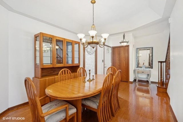 6919 Lexington Ct, Tinley Park, IL 60477 - dining area featuring wood finished floors, a chandelier, and a tray ceiling