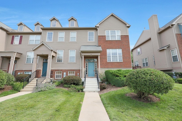 64 Village Station Ln, Grayslake, IL 60030 - townhome / multi-family property featuring brick siding and a front lawn