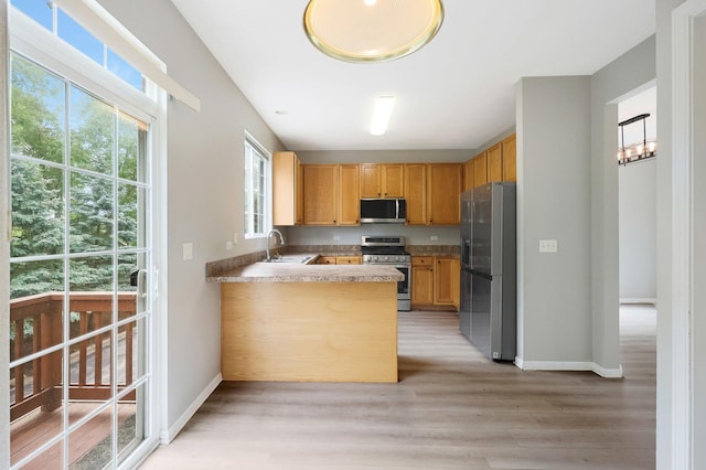 64 Village Station Ln, Grayslake, IL 60030 - kitchen featuring stainless steel appliances, light wood-style flooring, a peninsula, and light countertops