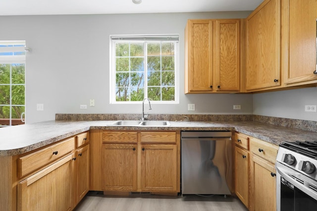 64 Village Station Ln, Grayslake, IL 60030 - kitchen with stainless steel appliances, light wood-type flooring, and a peninsula