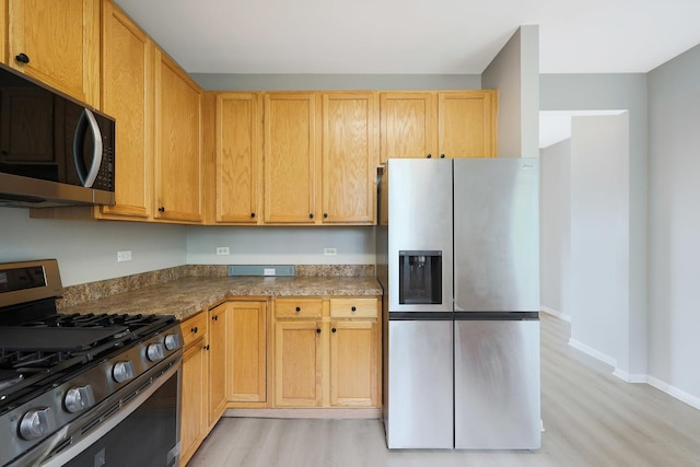 64 Village Station Ln, Grayslake, IL 60030 - kitchen with stainless steel appliances, light wood-type flooring, and dark countertops