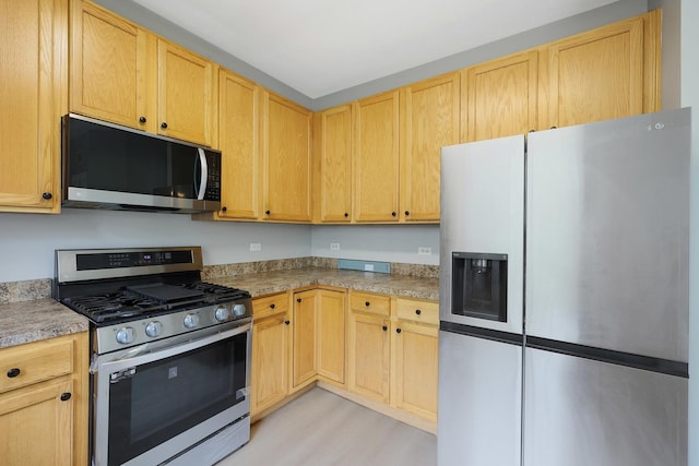 64 Village Station Ln, Grayslake, IL 60030 - kitchen featuring appliances with stainless steel finishes, light wood finished floors, light countertops, and light brown cabinetry