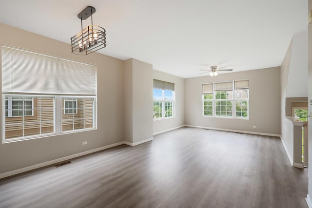 64 Village Station Ln, Grayslake, IL 60030 - unfurnished living room with wood finished floors, a chandelier, and ceiling fan