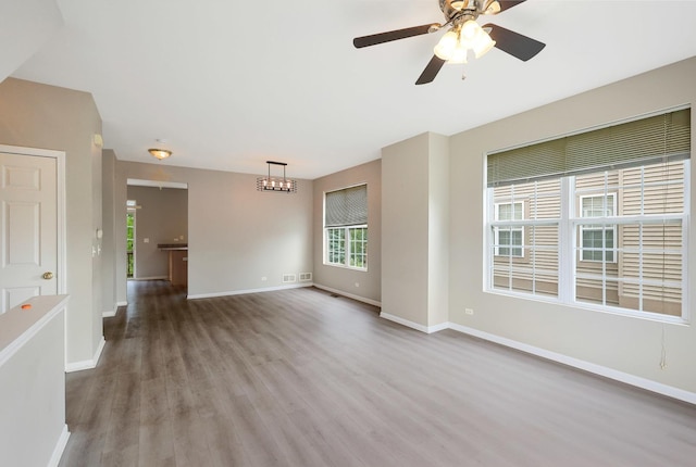 64 Village Station Ln, Grayslake, IL 60030 - unfurnished living room with wood finished floors and ceiling fan