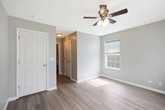 64 Village Station Ln, Grayslake, IL 60030 - unfurnished bedroom with wood finished floors and a ceiling fan
