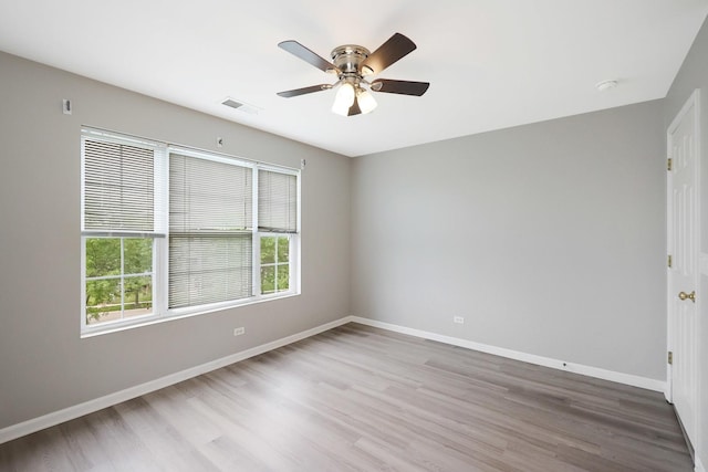 64 Village Station Ln, Grayslake, IL 60030 - spare room featuring wood finished floors, ceiling fan, and a smoke detector
