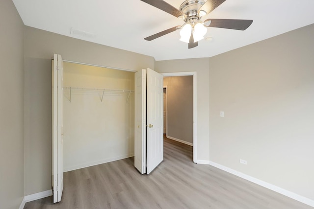 64 Village Station Ln, Grayslake, IL 60030 - unfurnished bedroom featuring light wood-type flooring, a closet, and a ceiling fan