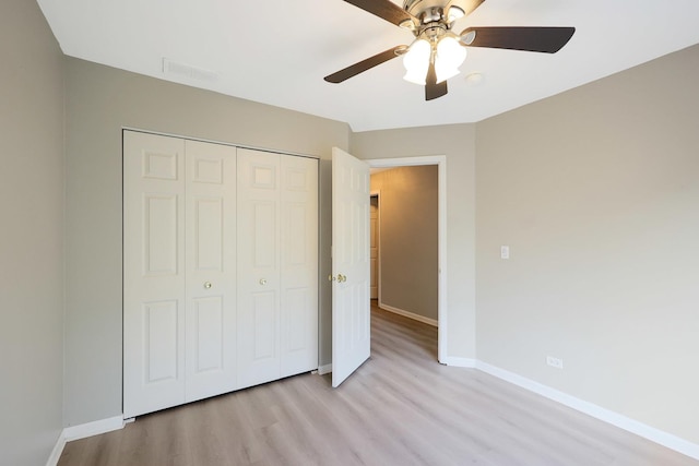 64 Village Station Ln, Grayslake, IL 60030 - unfurnished bedroom featuring light wood-style flooring, a closet, and a ceiling fan