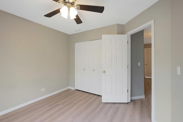 64 Village Station Ln, Grayslake, IL 60030 - unfurnished bedroom with light wood-style flooring, a closet, and a ceiling fan