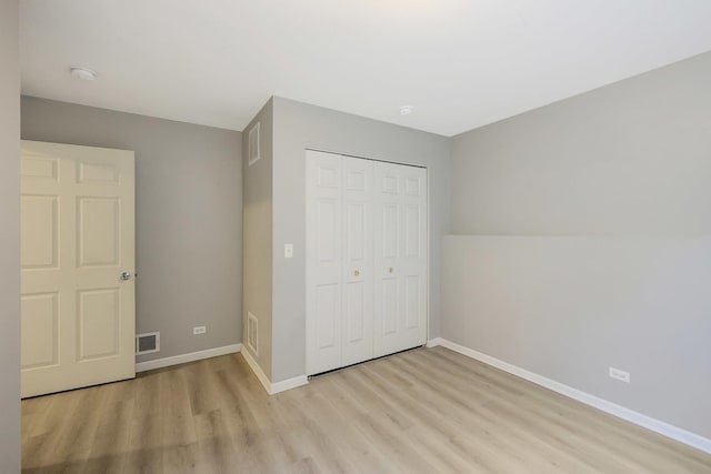 64 Village Station Ln, Grayslake, IL 60030 - unfurnished bedroom featuring light wood-style floors and a closet