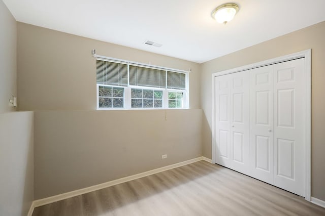 64 Village Station Ln, Grayslake, IL 60030 - unfurnished bedroom with light wood-type flooring and a closet