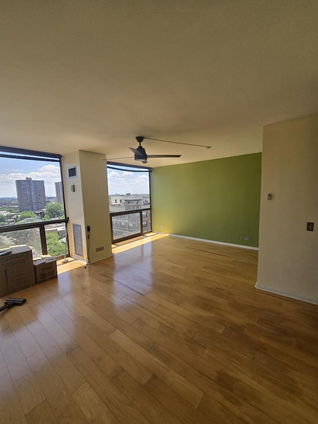 4343 N Clarendon Ave Unit 1301, Chicago, IL 60613 - spare room featuring ceiling fan, wood finished floors, and floor to ceiling windows