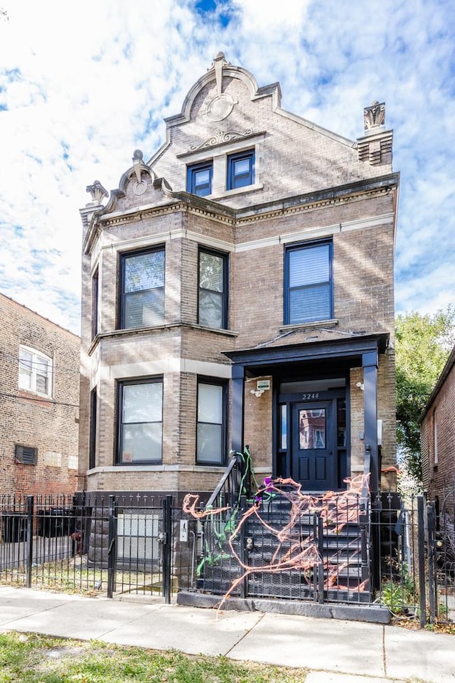 2244 S Sawyer Ave, Chicago, IL 60623 - view of front of home featuring a fenced front yard, brick siding, and a gate