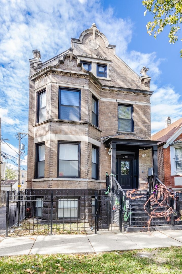 2244 S Sawyer Ave, Chicago, IL 60623 - view of front of property with a fenced front yard and brick siding