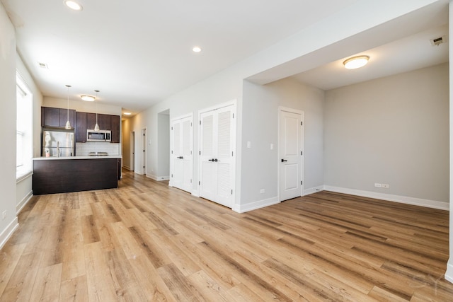 2244 S Sawyer Ave, Chicago, IL 60623 - unfurnished living room with light wood-style flooring and recessed lighting