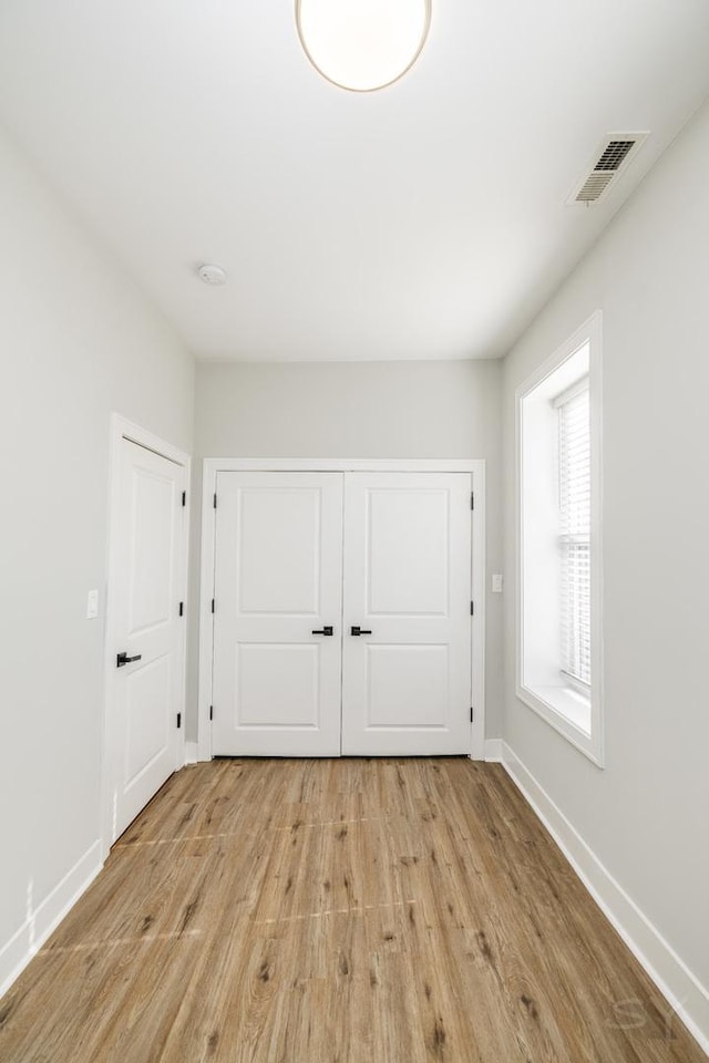 2244 S Sawyer Ave, Chicago, IL 60623 - unfurnished bedroom featuring light wood-style floors and a closet