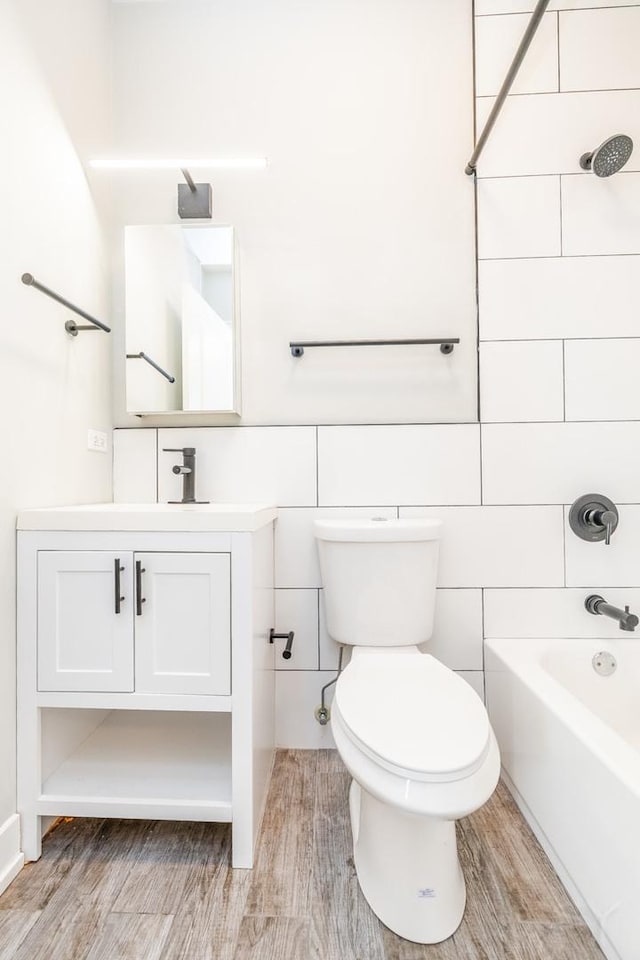 2244 S Sawyer Ave, Chicago, IL 60623 - bathroom with vanity, shower / bath combination, wood finished floors, and tile walls