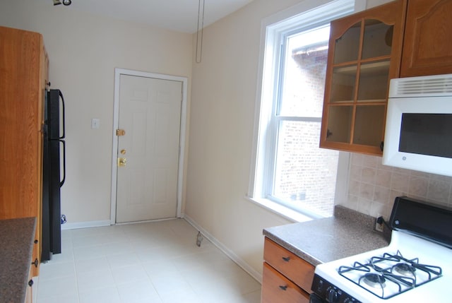 6207 N Winthrop Ave Unit 30, Chicago, IL 60660 - kitchen with white appliances, tasteful backsplash, brown cabinetry, and healthy amount of natural light