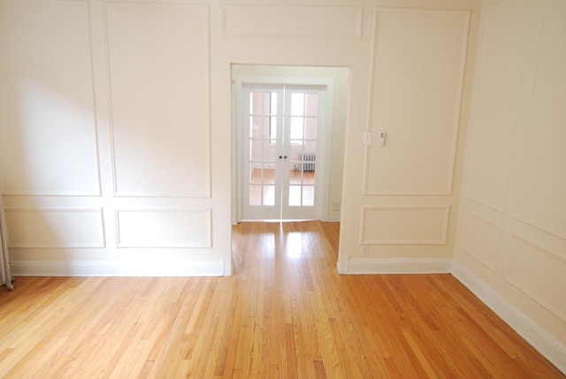 6207 N Winthrop Ave Unit 30, Chicago, IL 60660 - spare room featuring a decorative wall, light wood-style floors, and french doors