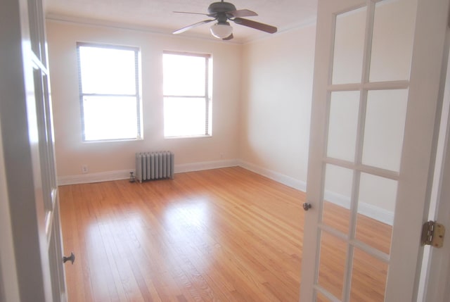 6207 N Winthrop Ave Unit 30, Chicago, IL 60660 - empty room with radiator heating unit, ornamental molding, a ceiling fan, and light wood-style floors